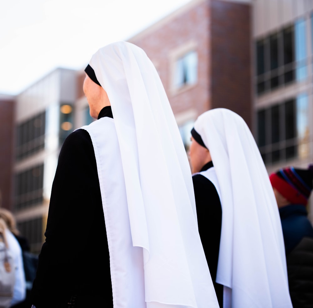 a group of women dressed in black and white