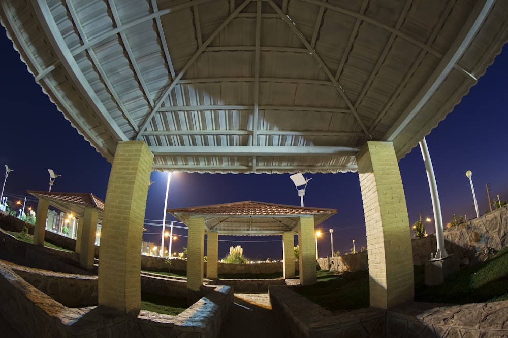 a gazebo lit up at night in a park