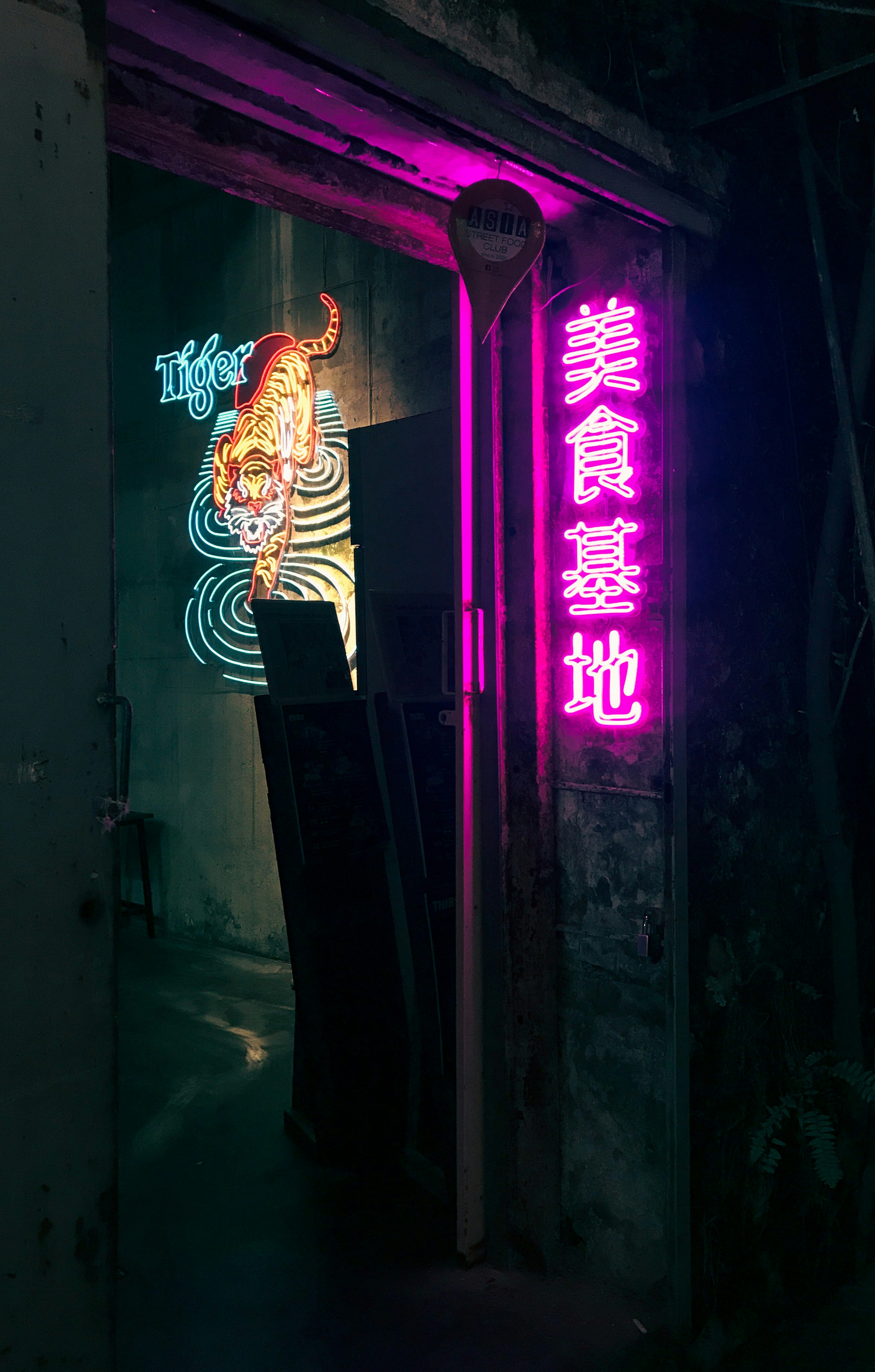 a neon sign is lit up in a dark room