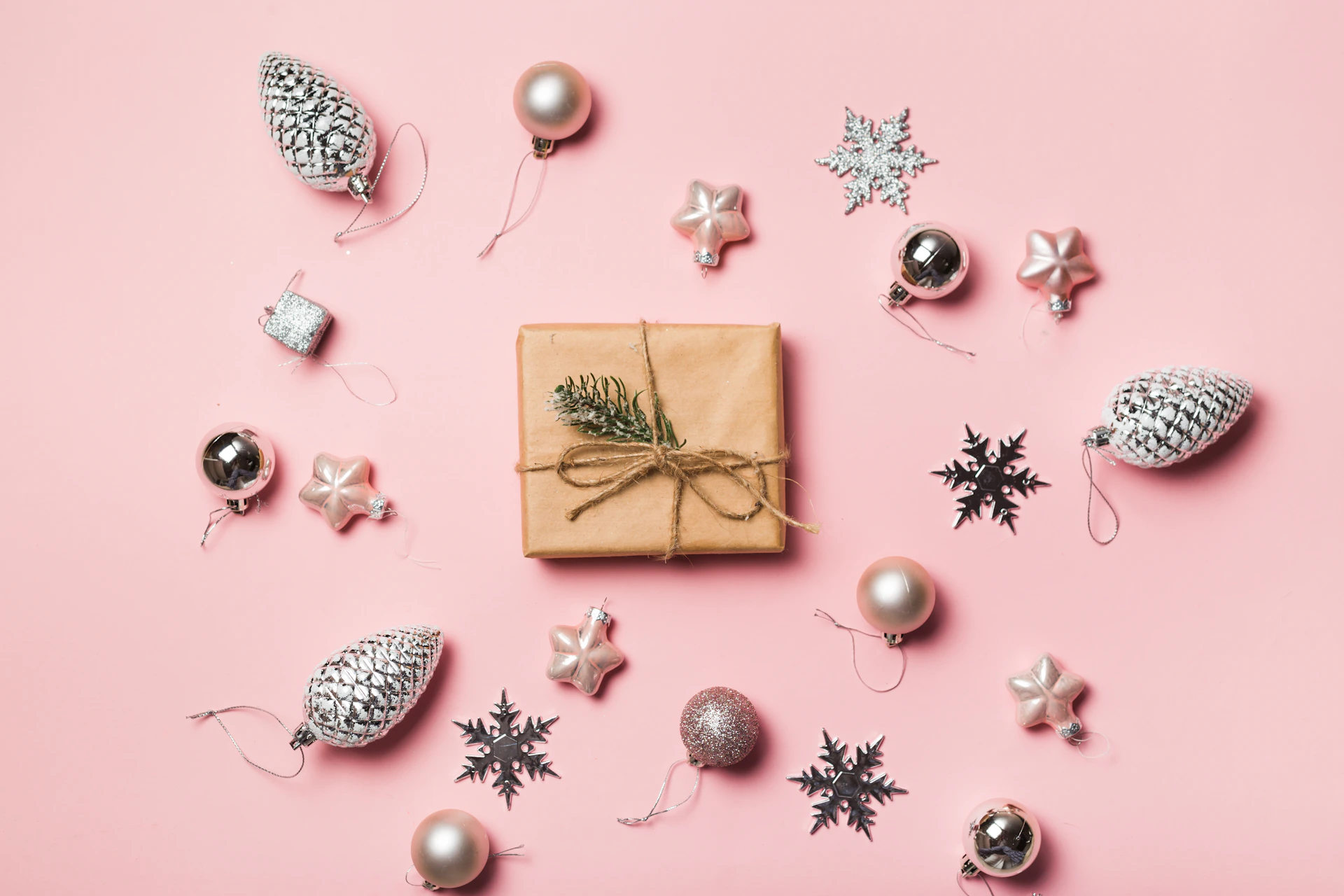 a present wrapped in brown paper surrounded by christmas ornaments