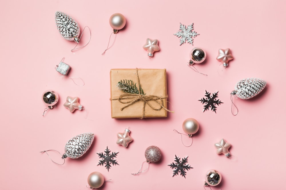 a present wrapped in brown paper surrounded by christmas ornaments