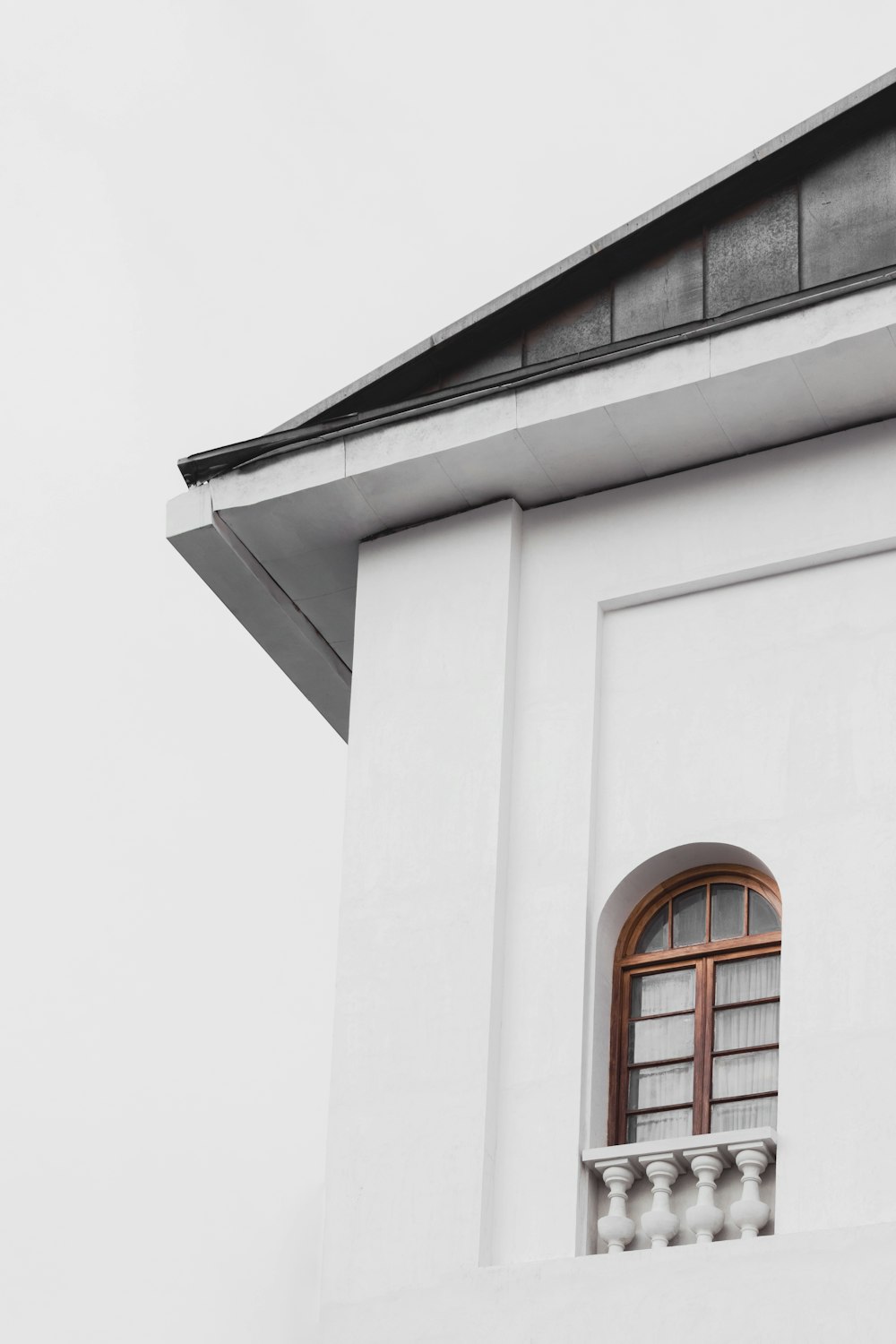 a white building with a clock on the side of it