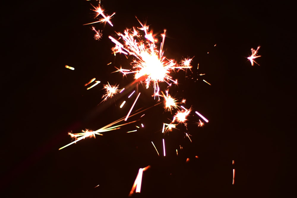 a firework is lit up in the night sky