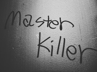 a black and white photo of a wall with writing on it