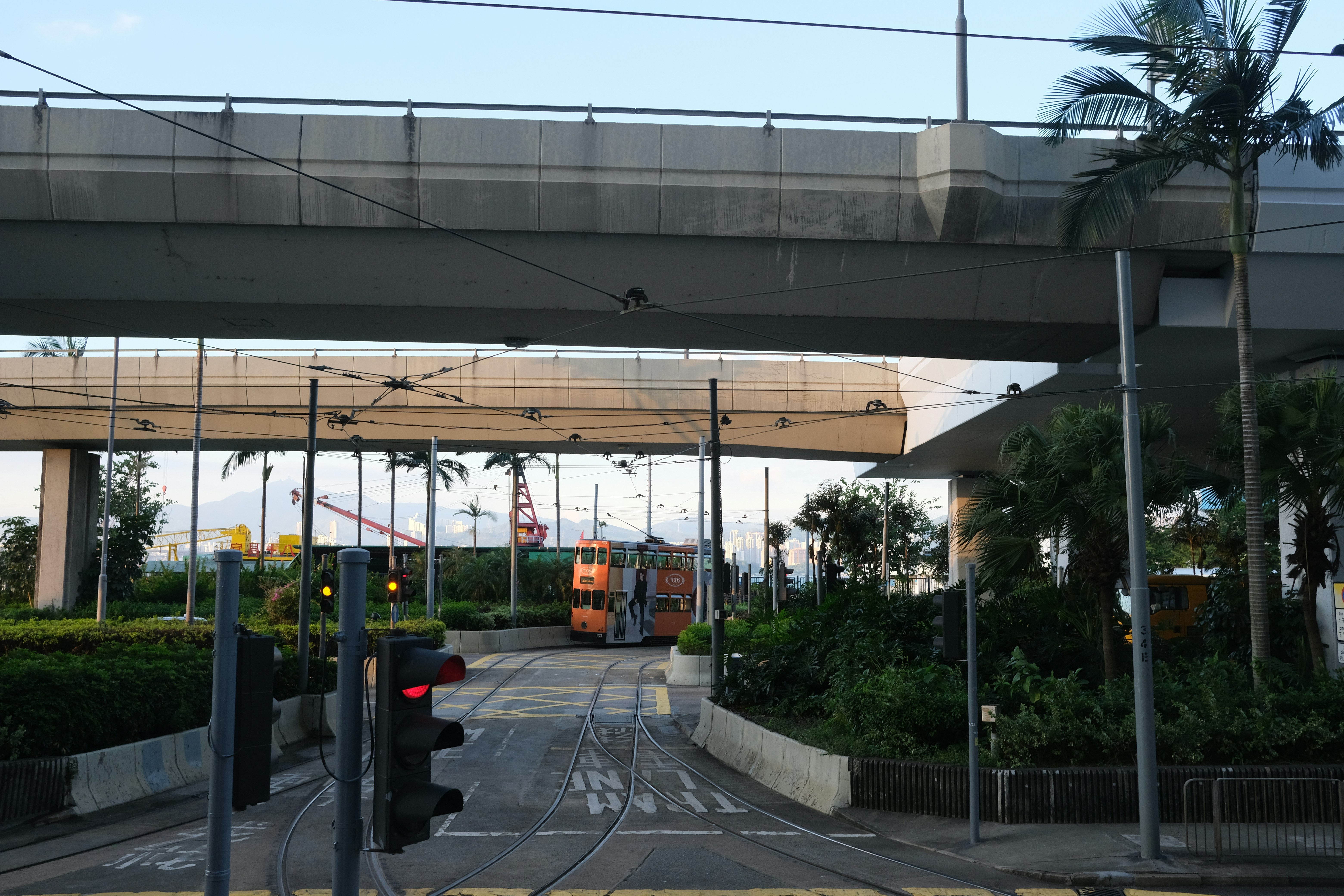a traffic light sitting under a bridge next to a street