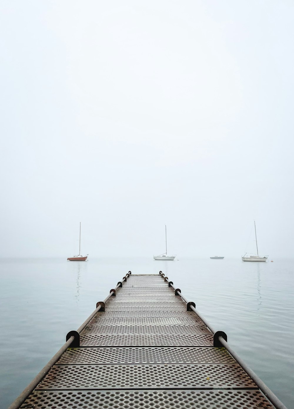 a dock with a few boats in the water