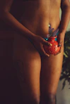 a woman in a bikini holding a potted plant