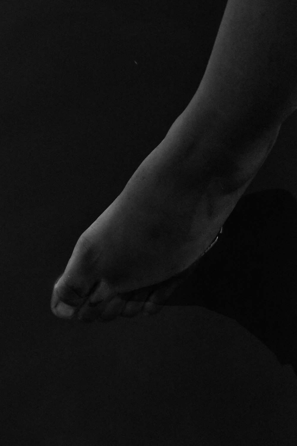 a black and white photo of a person's foot