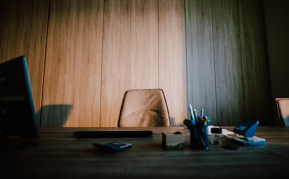 a laptop computer sitting on top of a wooden table