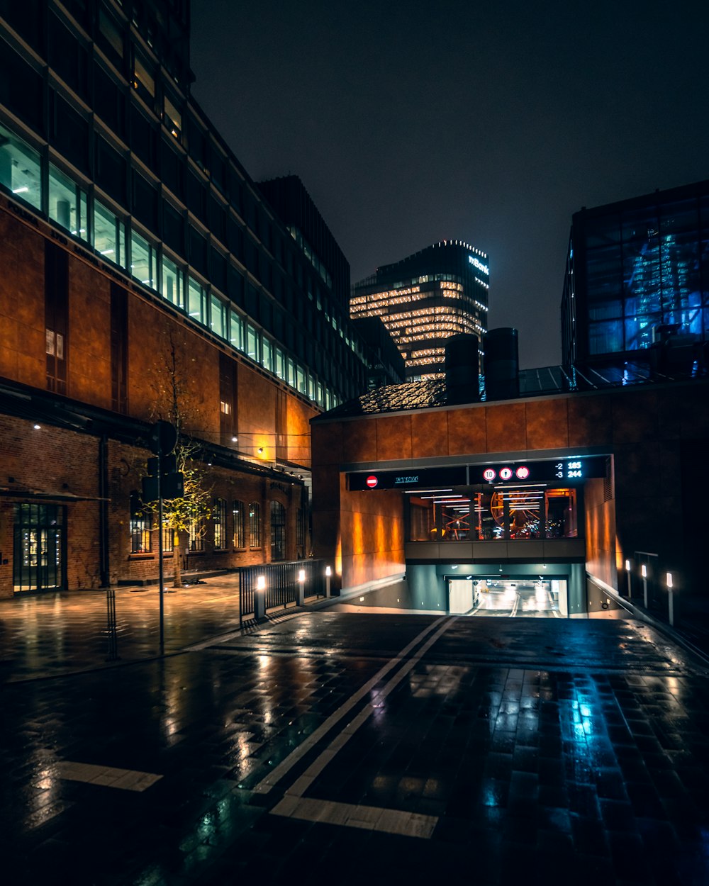 a city street at night with buildings lit up