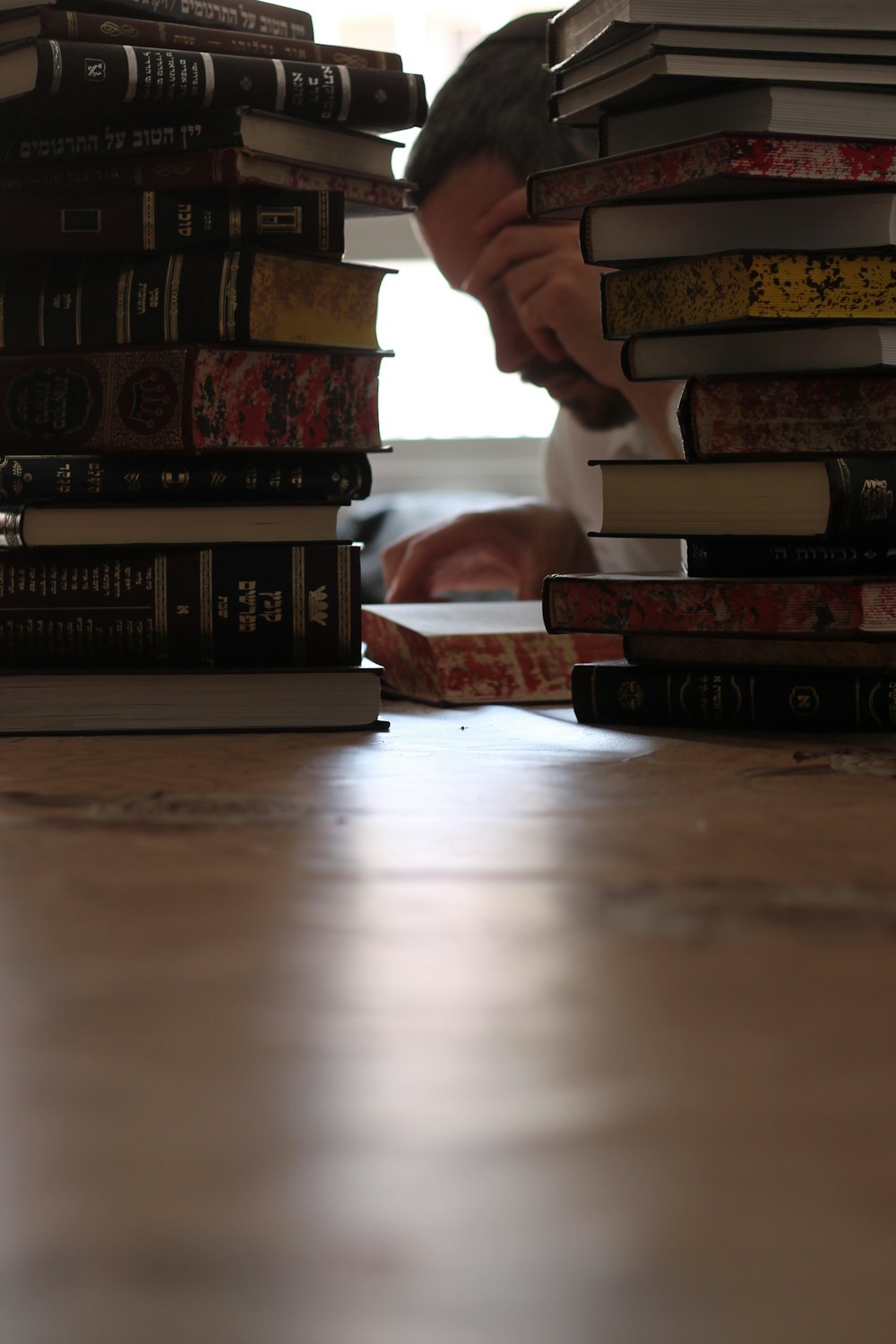 a stack of books sitting on top of a wooden table