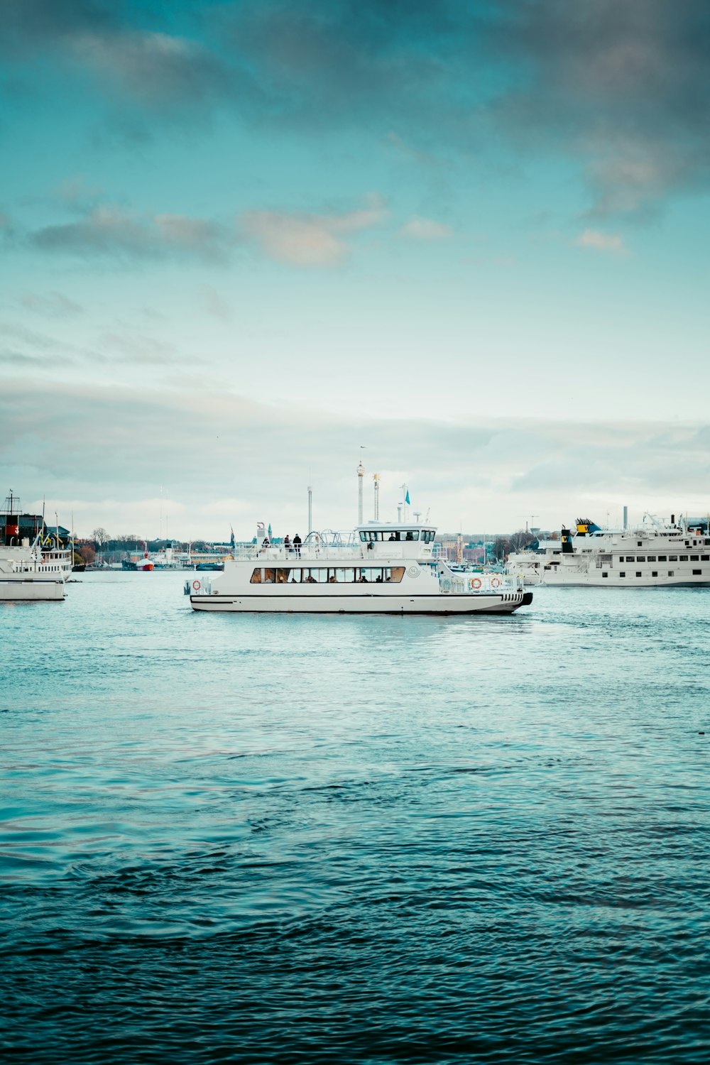 a group of boats floating on top of a large body of water