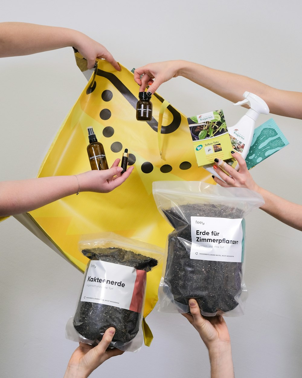 a group of people holding up bags of food