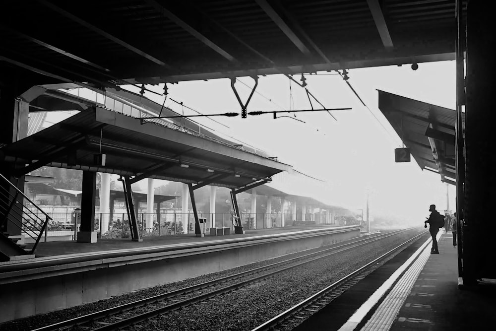 a black and white photo of a train station