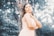 A serene outdoor setting with a woman confidently posing in a flowing dress, surrounded by lush greenery and majestic mountains.