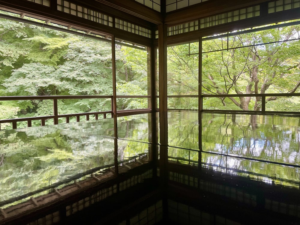 a room with a view of the water and trees