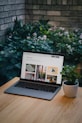 a laptop computer sitting on top of a wooden table