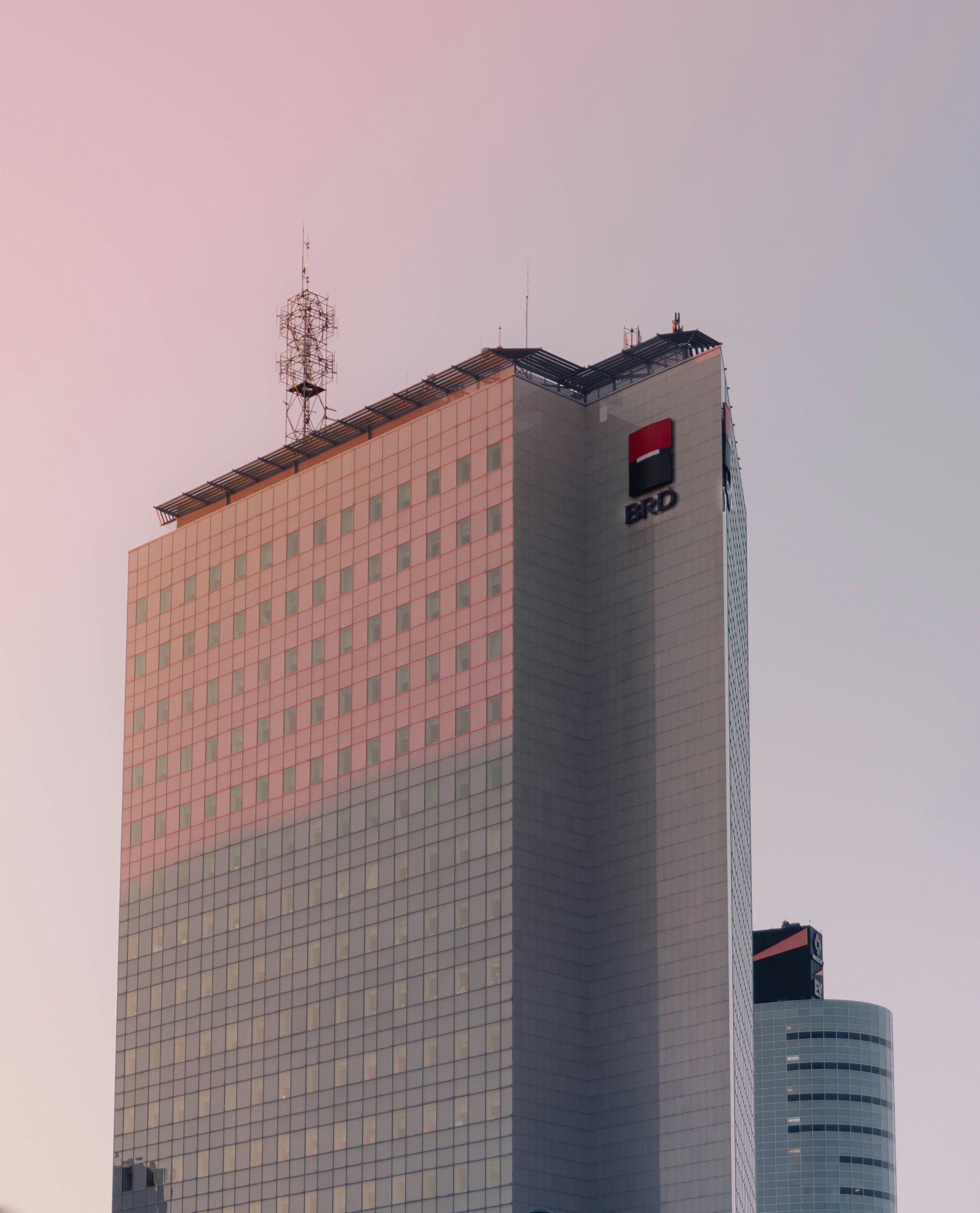 a tall building with a red and black logo on it