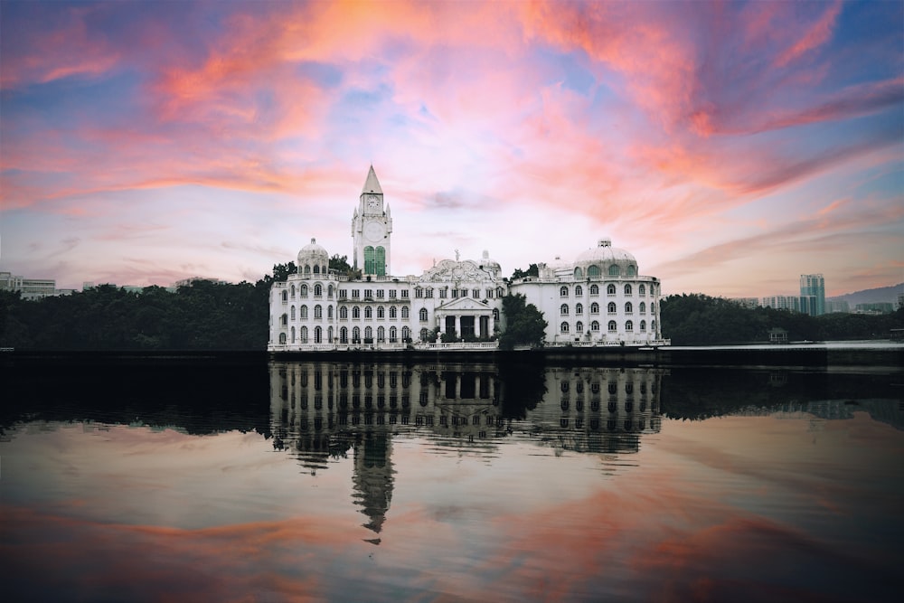 a large white building sitting on top of a lake