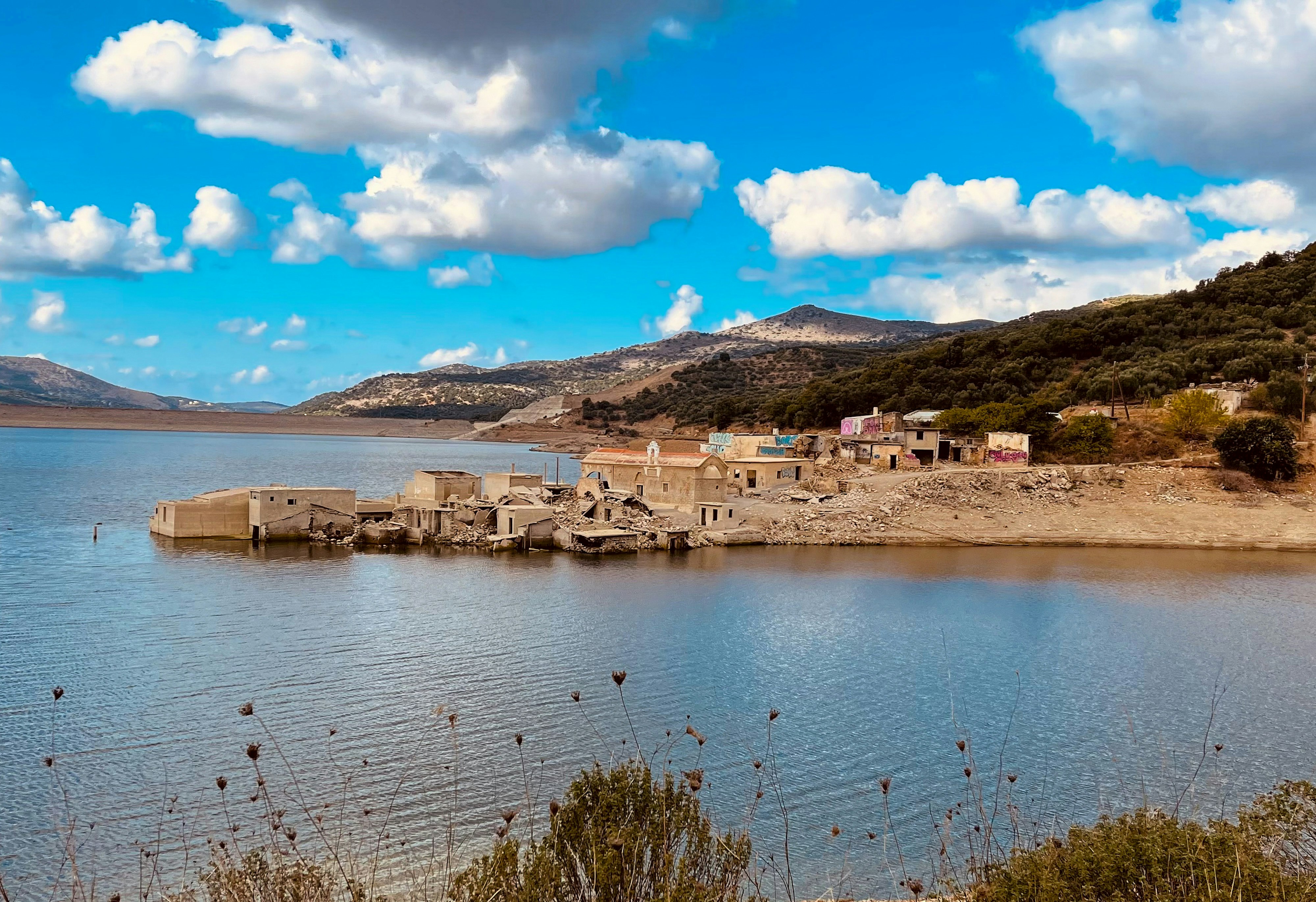 Sfentyli village under the blue sky and flooded and sunk under the water of Aposelemis dam