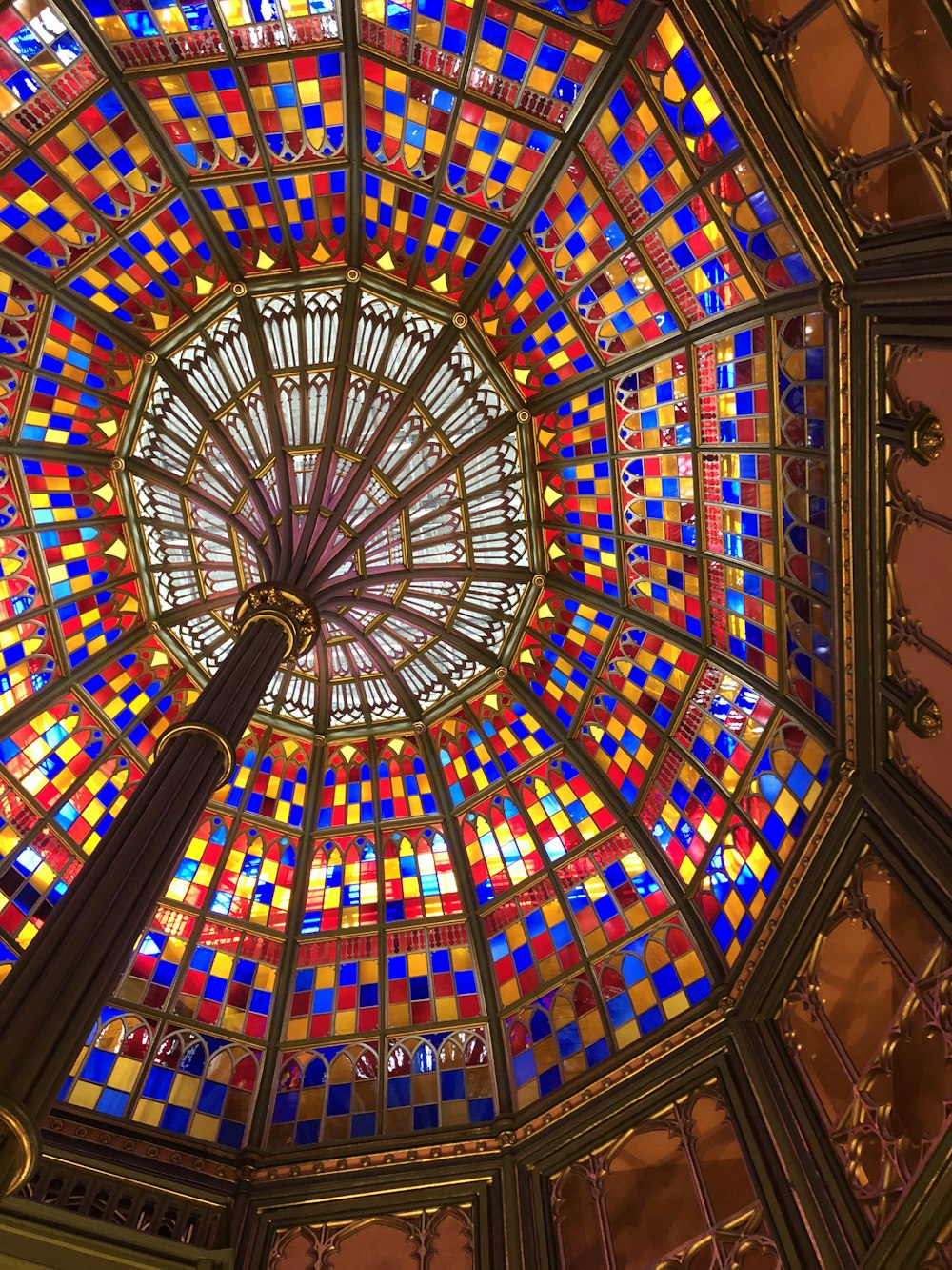 a colorful stained glass ceiling in a building