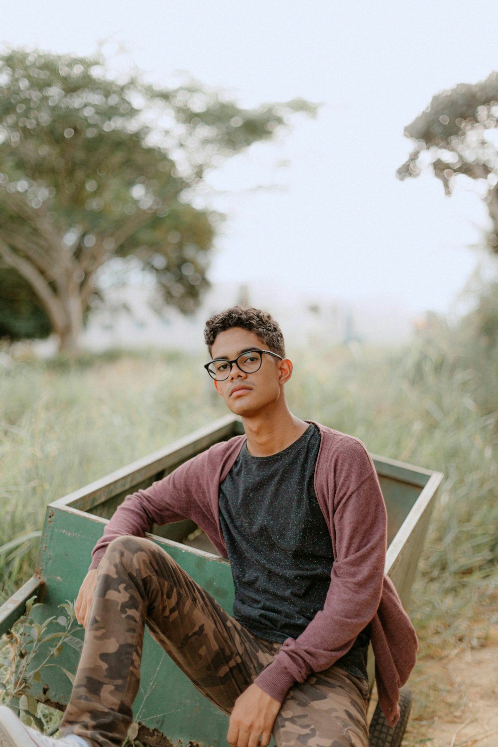 a man sitting in a boat in a field