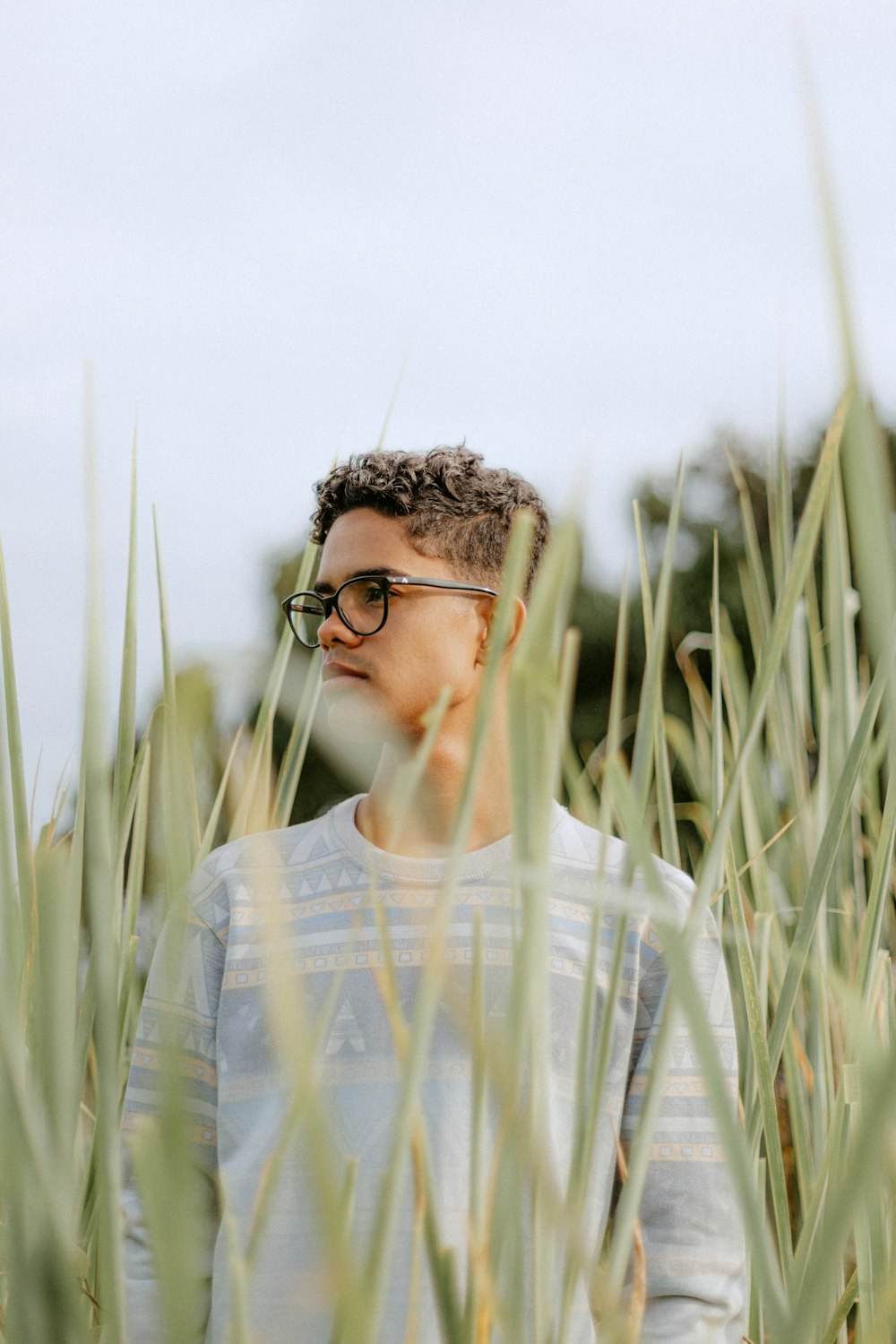 a man standing in a field of tall grass