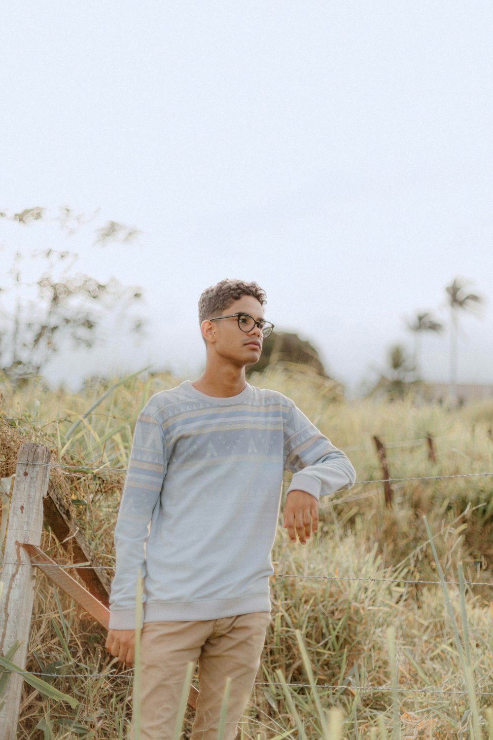 a man standing in a field of tall grass