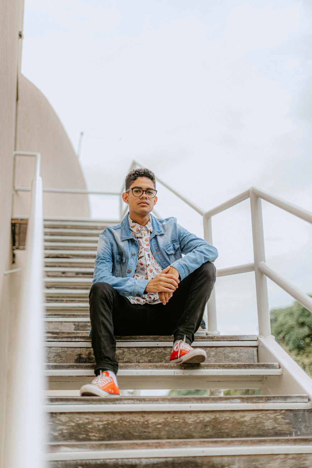 a man sitting on top of a set of stairs