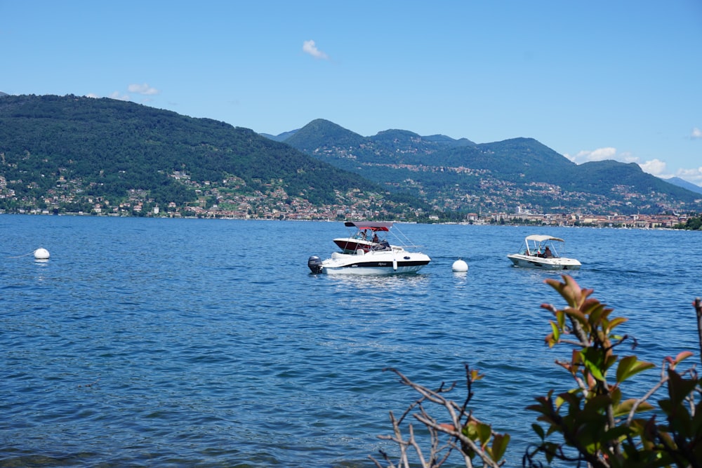 a couple of boats floating on top of a lake