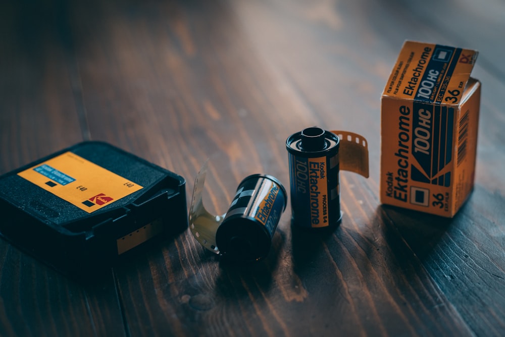 a couple of batteries sitting on top of a wooden table