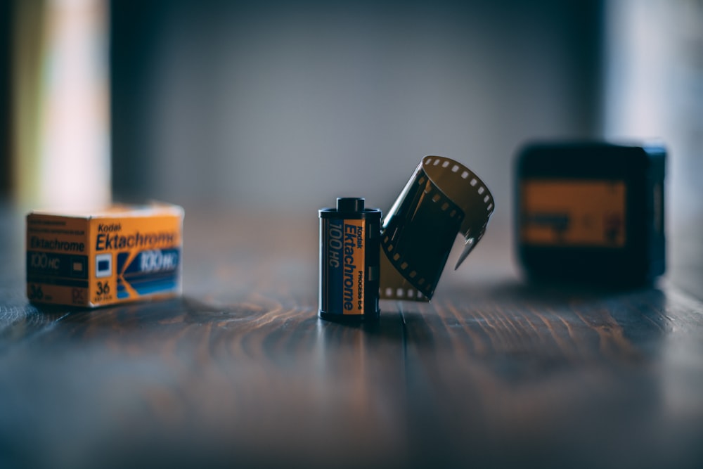 a couple of batteries sitting on top of a wooden table