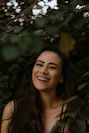 a woman with long dark hair smiling at the camera