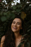 a woman with long dark hair smiling at the camera