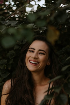 a woman with long dark hair smiling at the camera