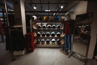 a man standing in front of a rack of hats