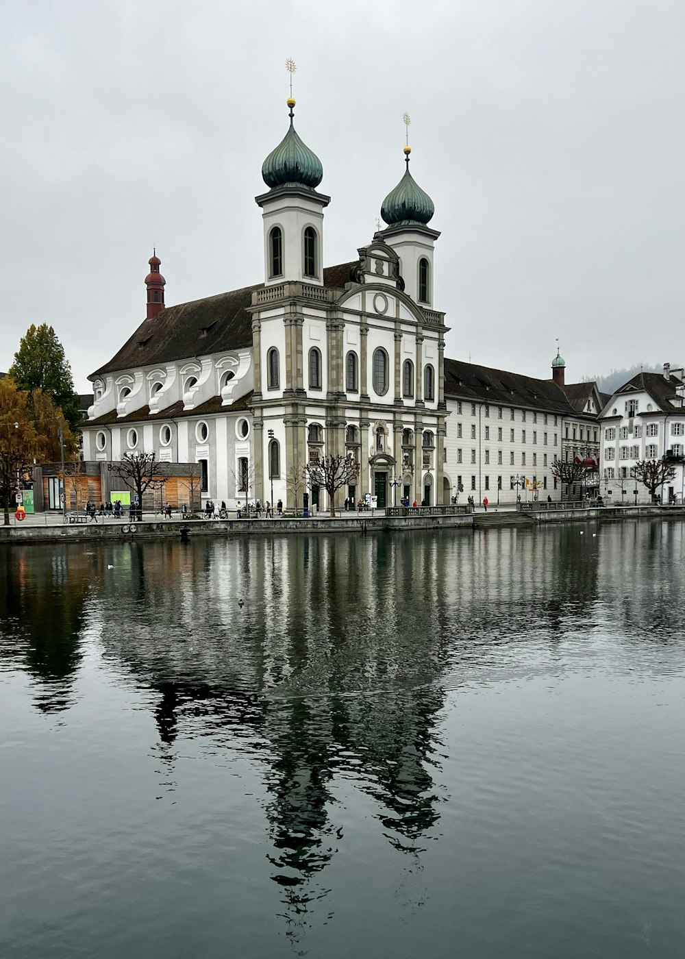 a large white building sitting next to a body of water