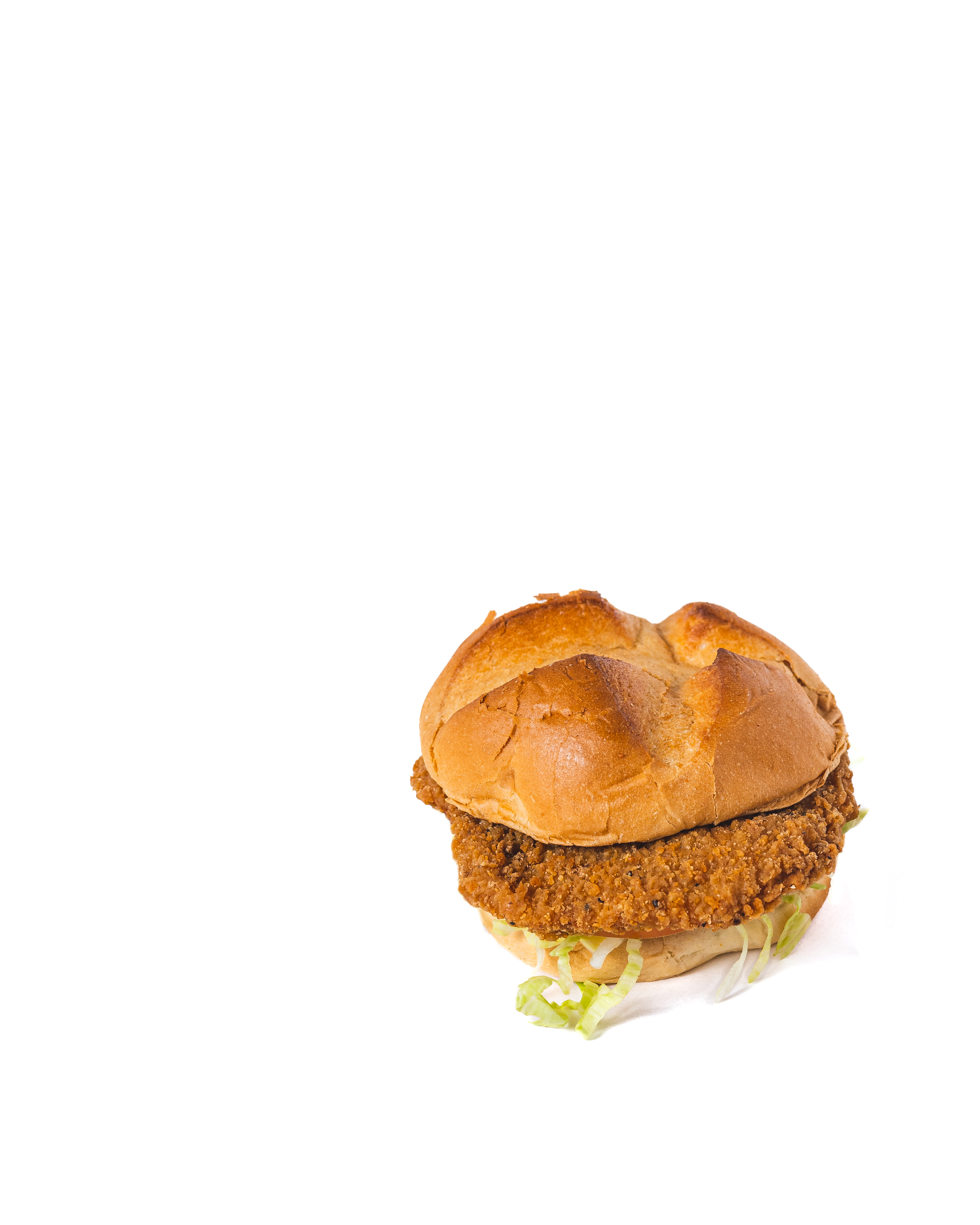 Crispy golden fried chicken burger with coleslaw on potato bun, bright food photography