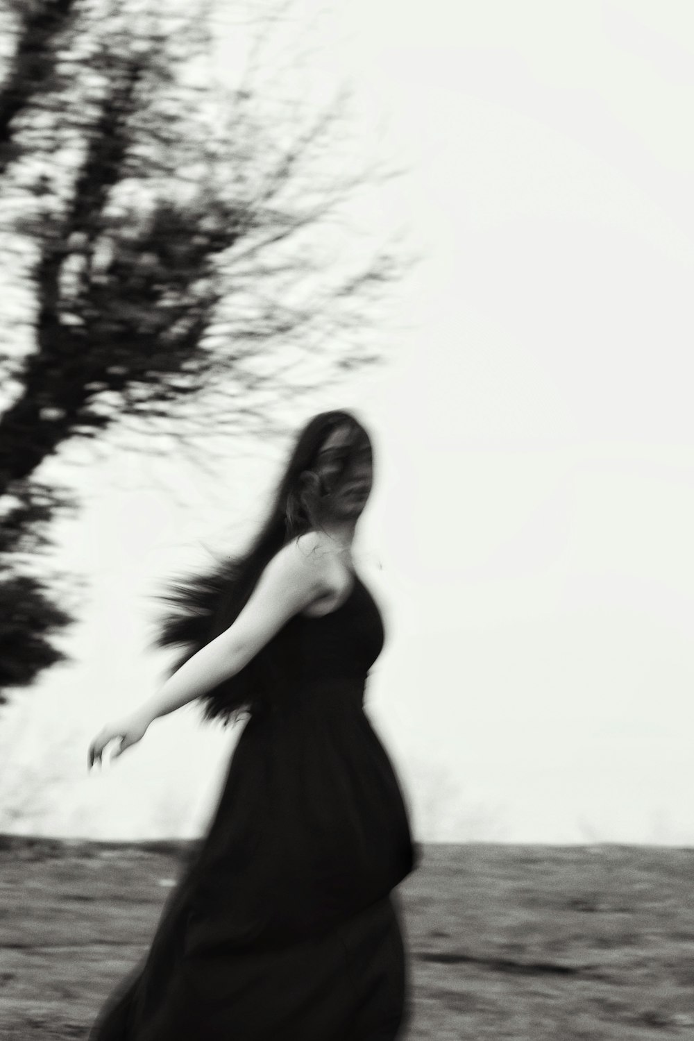 a woman in a long black dress is running