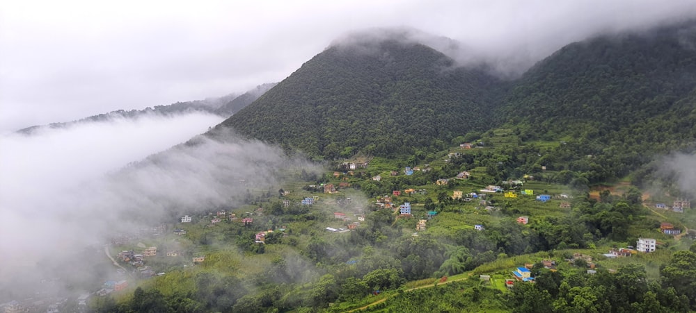 a village nestled in the mountains surrounded by clouds