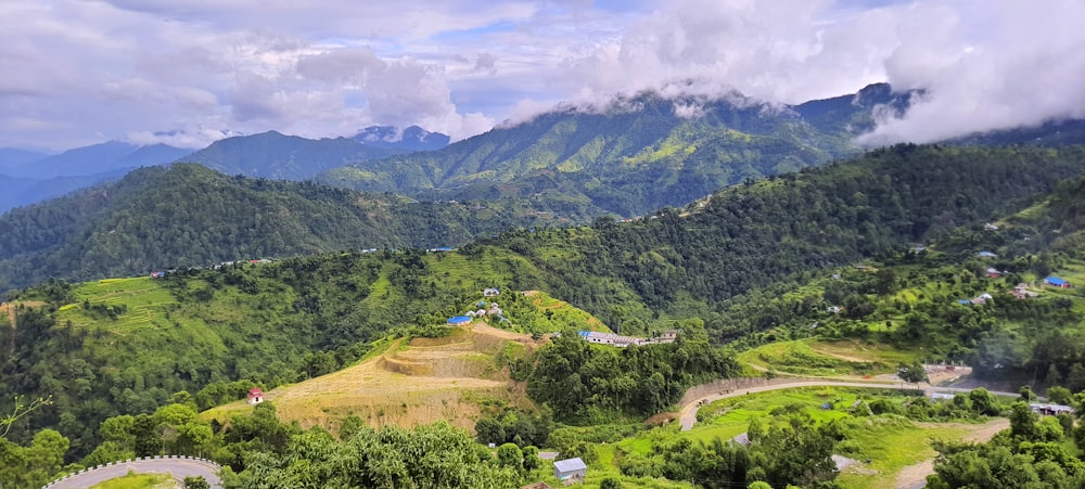 a scenic view of a valley with mountains in the background