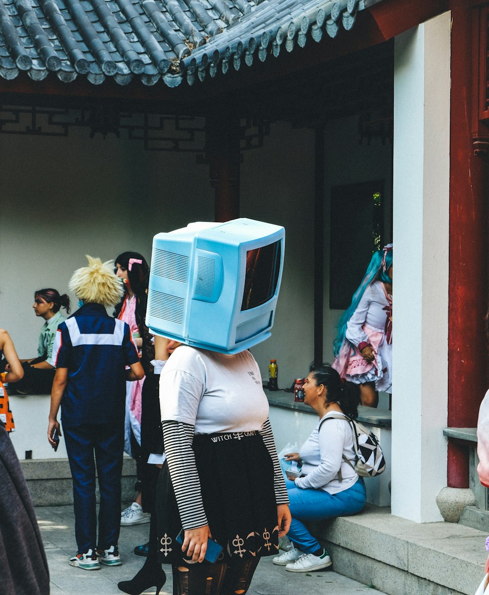 a group of people standing around a building