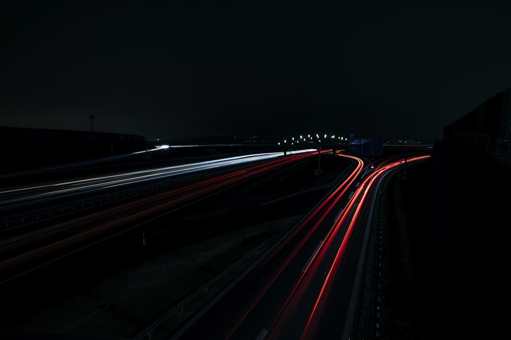 a long exposure photo of a highway at night