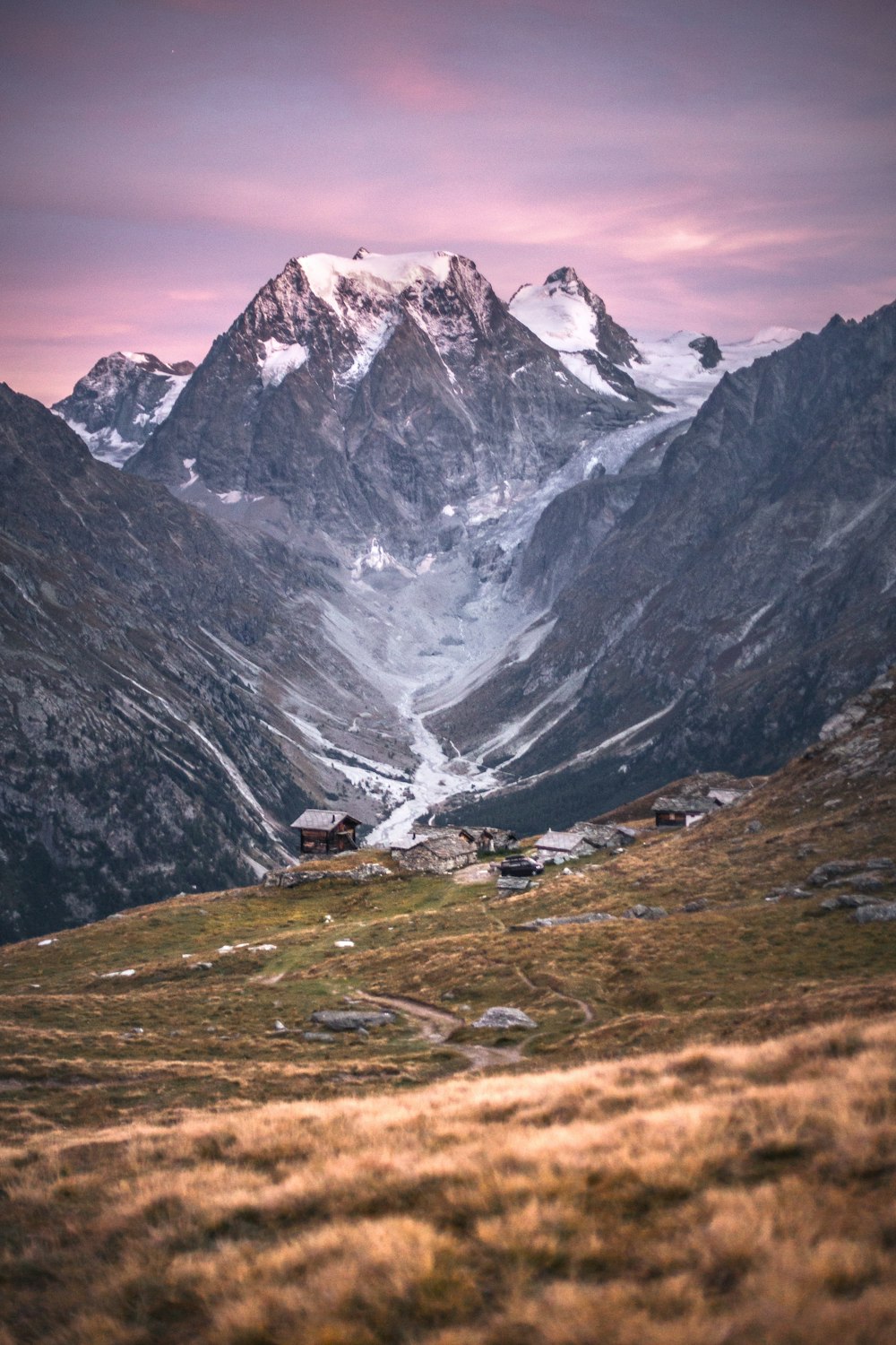 a mountain range with a snow covered mountain in the background