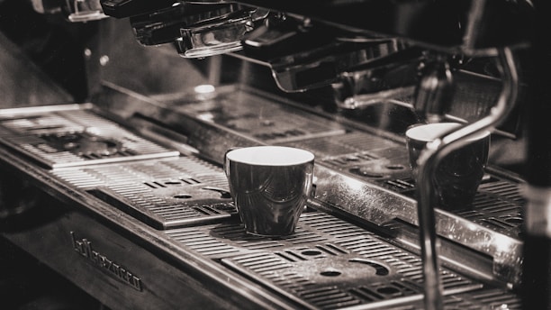 a coffee machine with two cups on top of it