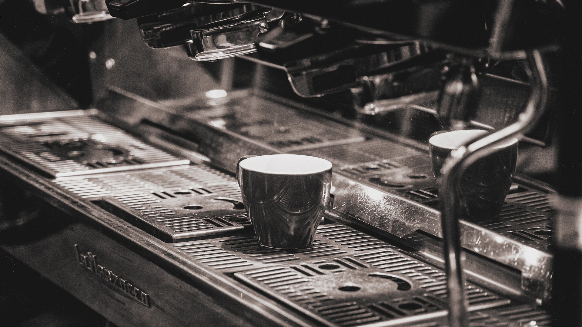 a coffee machine with two cups on top of it