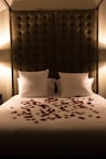 a bed with a bunch of rose petals on it