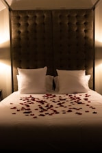 a bed with a bunch of rose petals on it