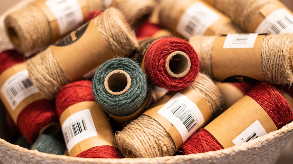 a basket filled with lots of different colored yarn