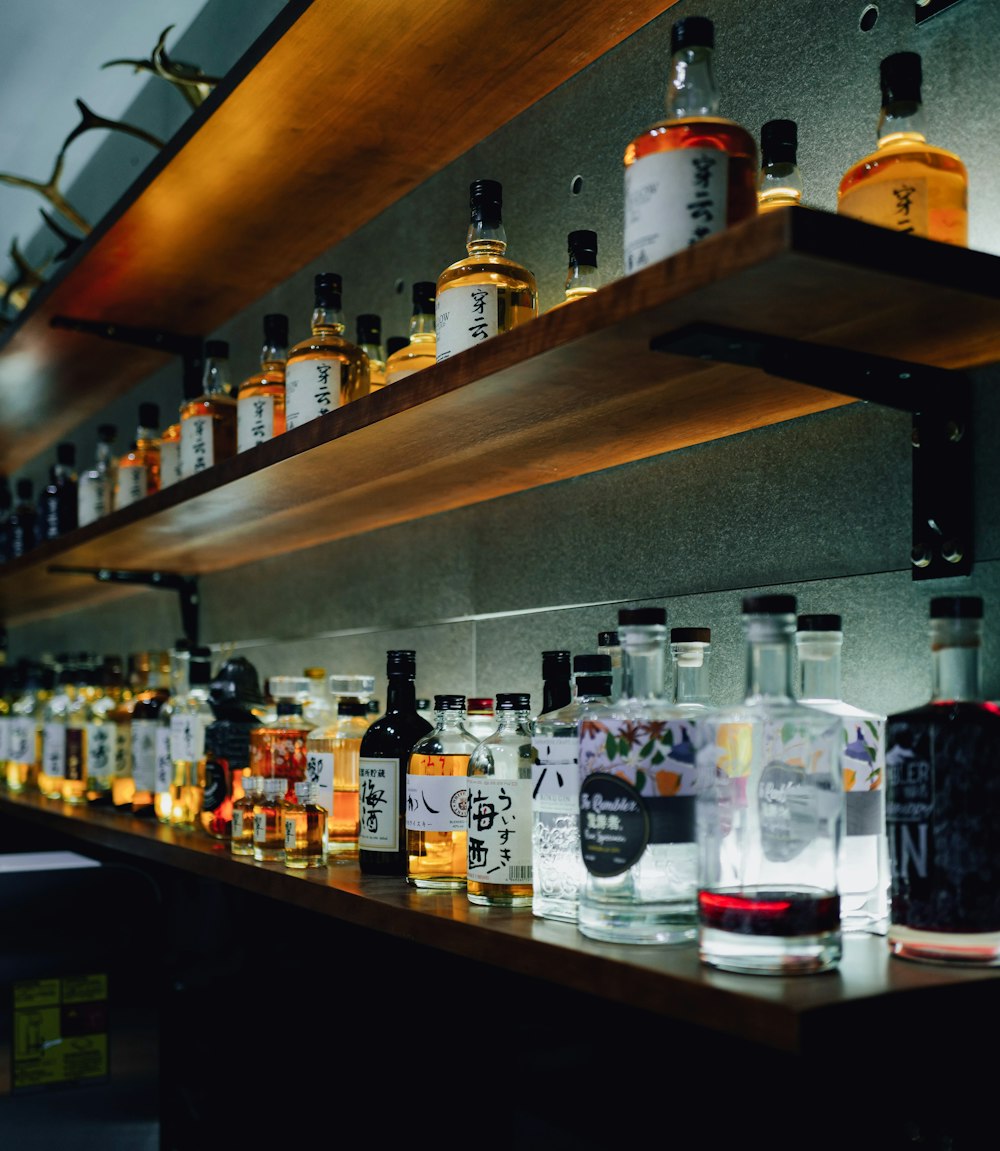 a shelf filled with lots of bottles of liquor